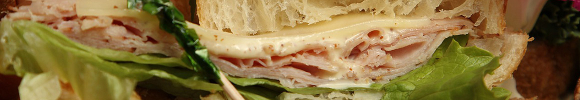 Eating Sandwich at Metcalf's Submarine Sandwiches restaurant in Damariscotta, ME.